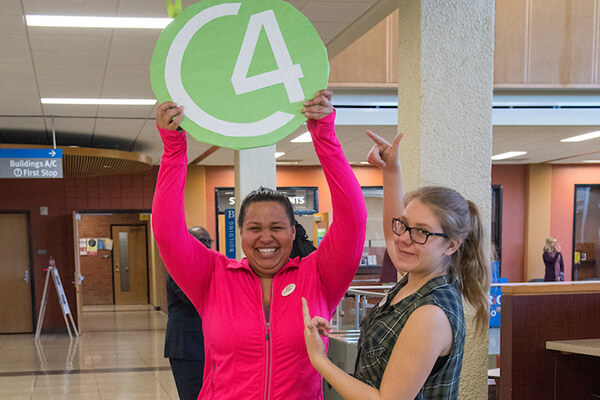 ECC Faculty holding a sign with the letters C4
