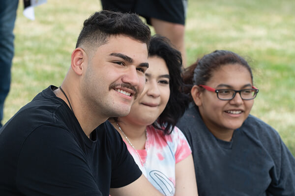 Students sitting together on the lawn at ECC