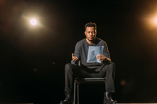 Actor holding scenario on stage during rehearse -