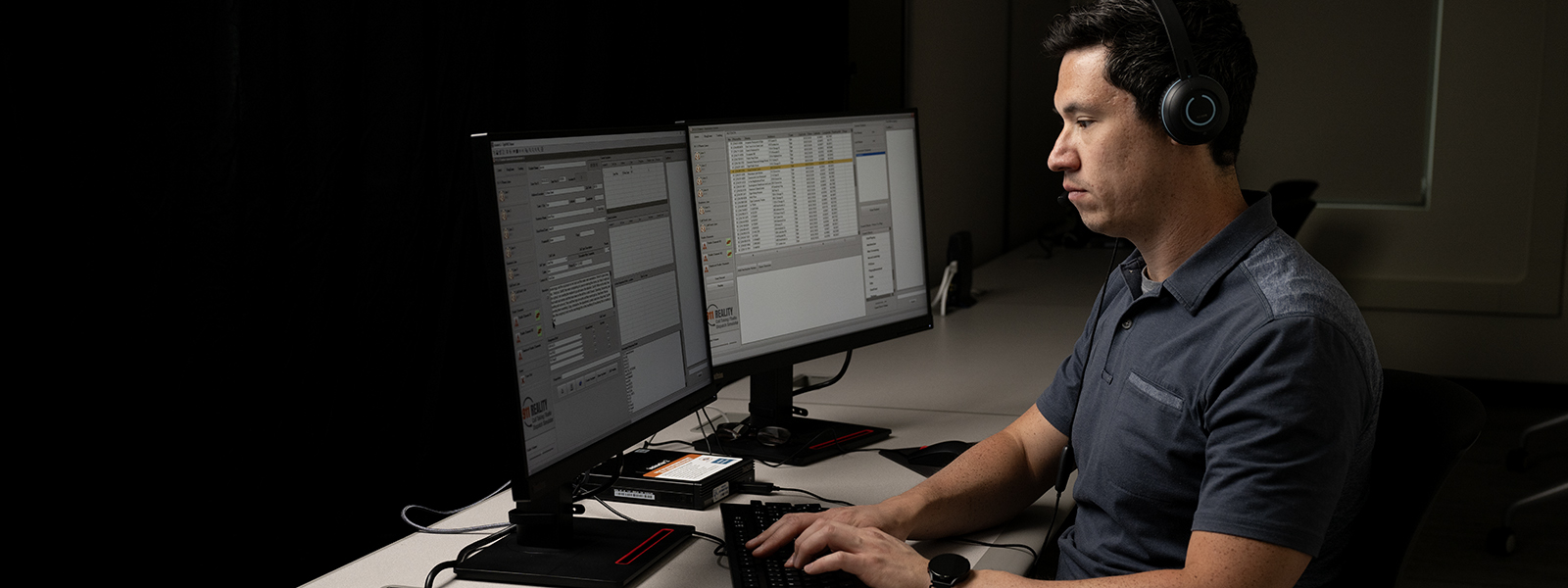 Dispatcher student looking at computer monitors