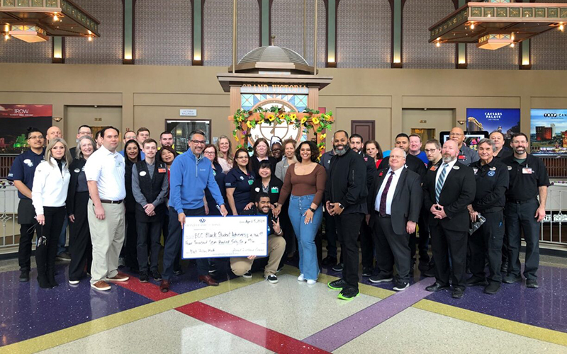 Erik Enders, student life coordinator for student equity, accepts a donation check, along with two ECC students and BSA club members, from the Grand Victoria Casino