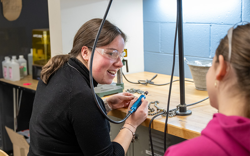 A student sits at workbench