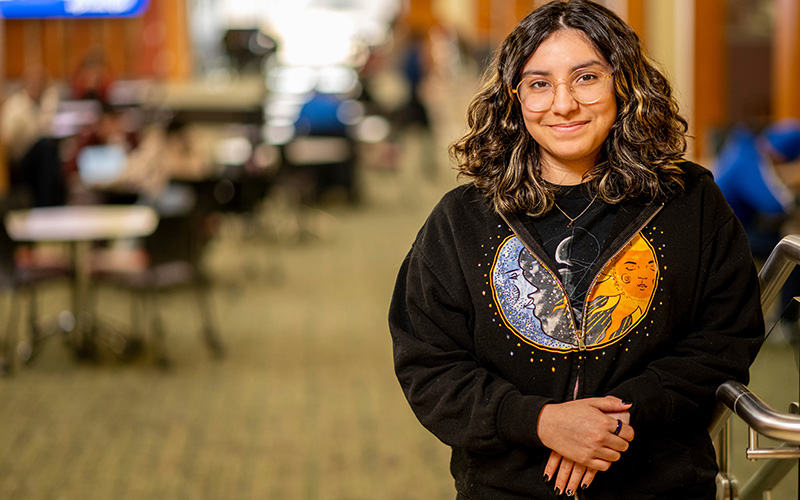 A student stands in the student lounge
