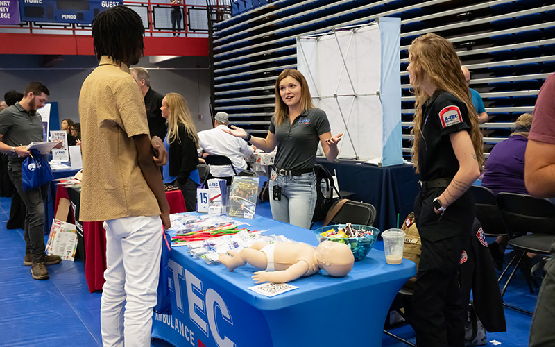 Students visiting employer tables at the job fair