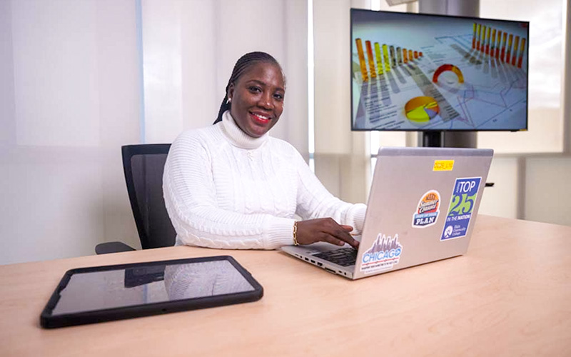A woman sitting at the desk smiling at the camera