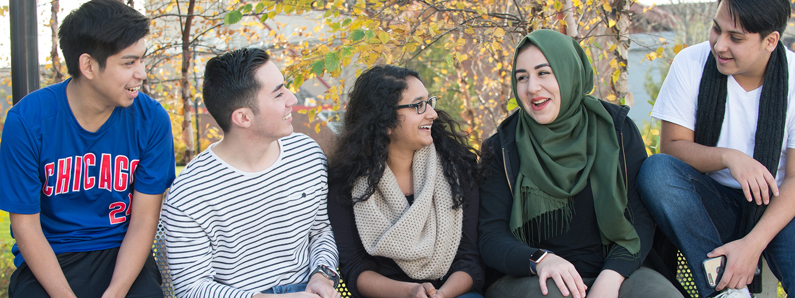 Students sitting on a bench together