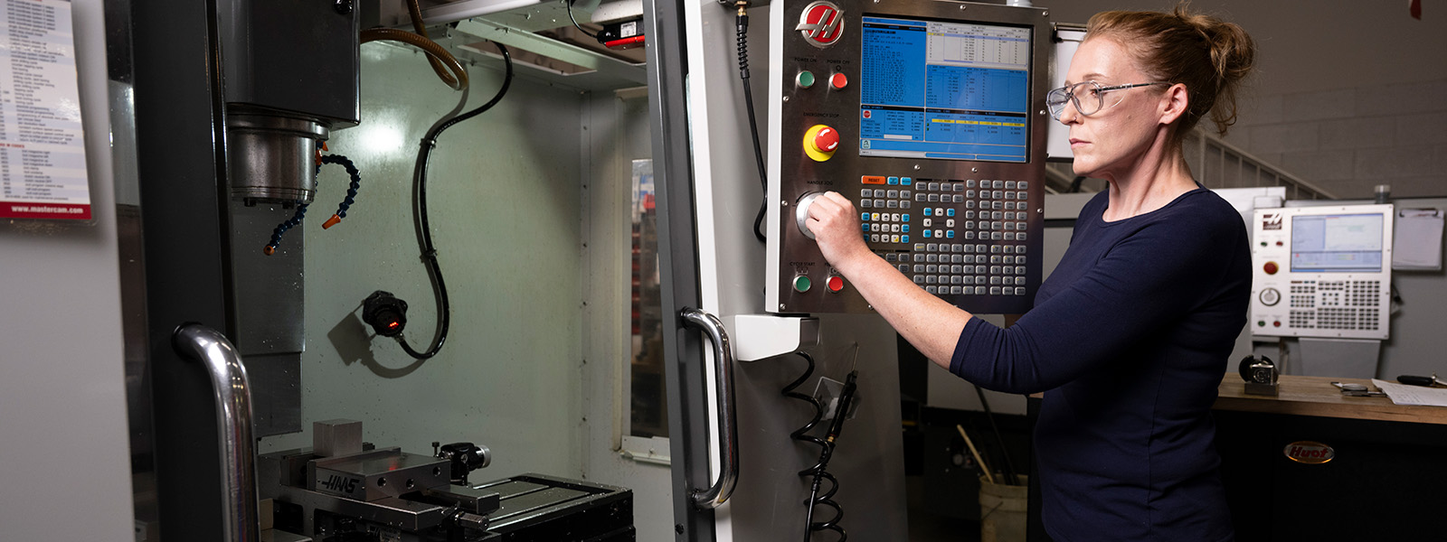 Student operating a CNC machine