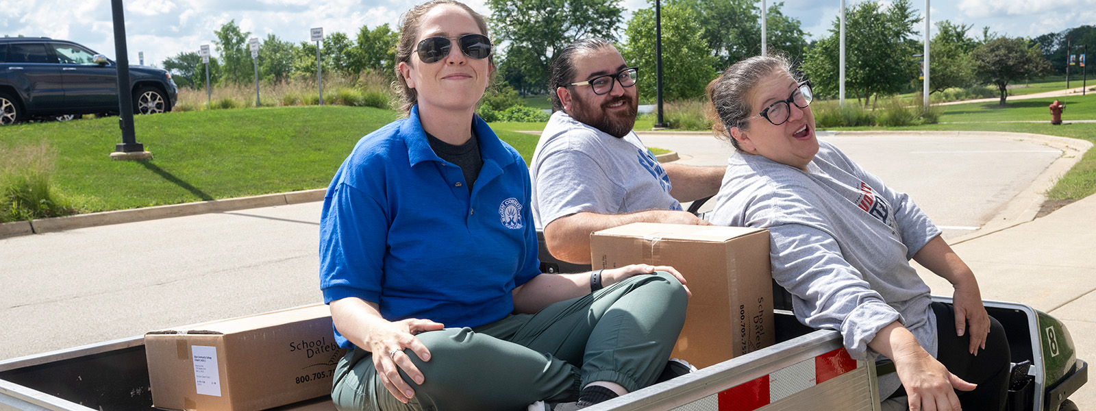 Staff riding in a golf cart