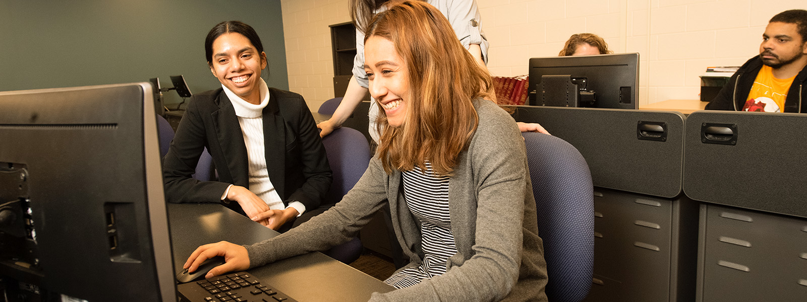 Group of students looking at a computer