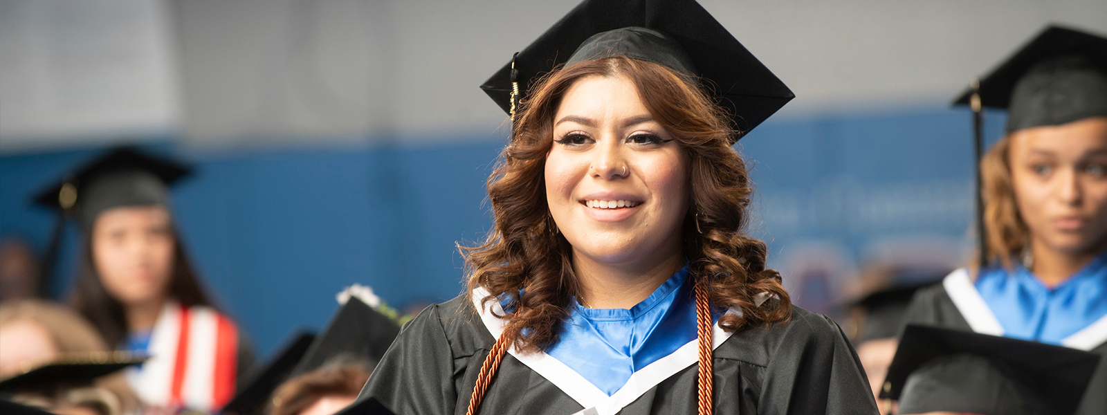 Honors students standing and being recognized at graduation