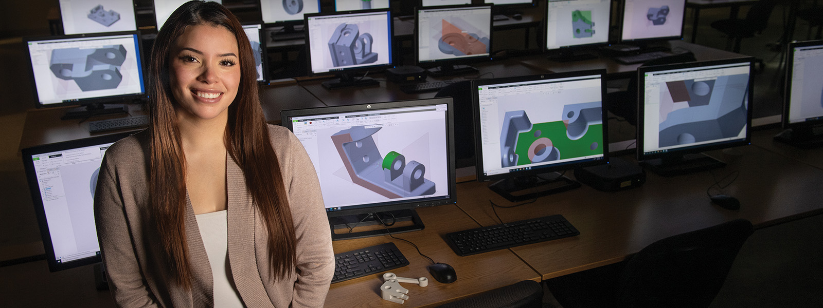Student leaning on table in engineering computer lab