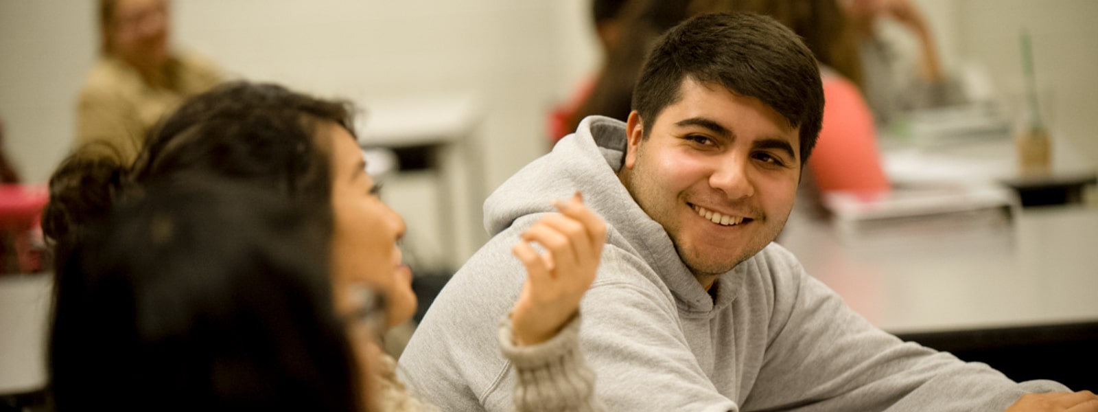 Students in a classroom having a conversation.