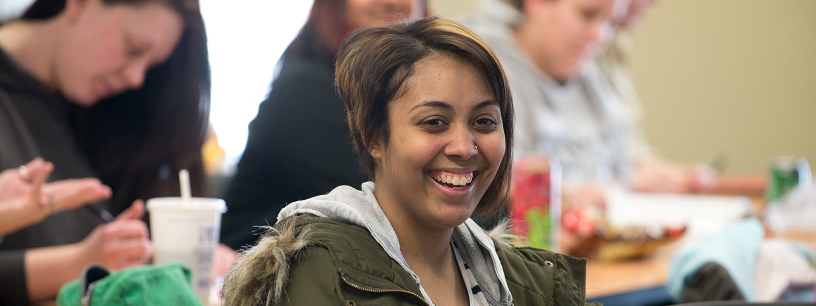 A student smiling in a classroom.