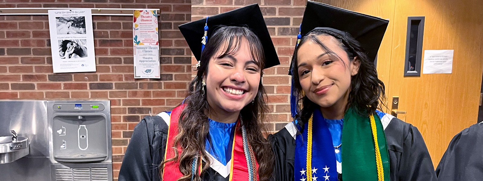 Two TRiO graduates smile for the camera