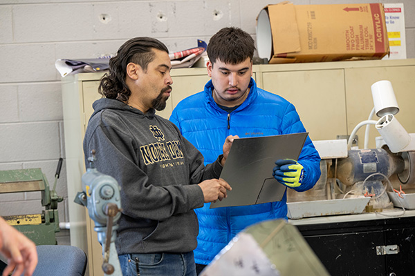 student with instructor looking at clipboard